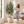 Artificial Olive Tree – decorative stone-look planter beside a woman