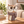 Cream and brown owl-shaped holder with round black glasses and a textured taupe scarf